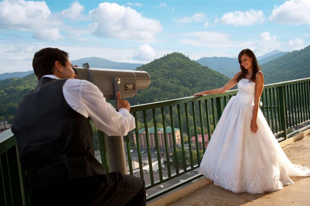 Man Looking at Bride Through Telescope