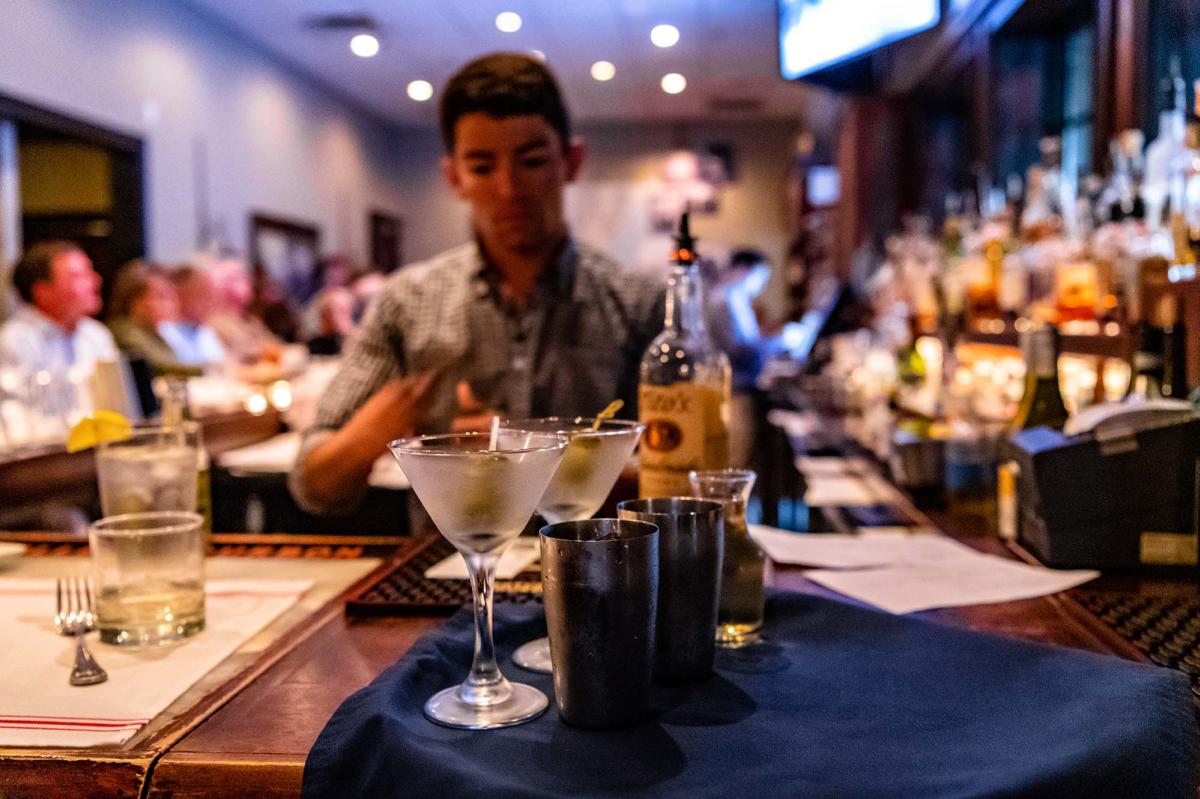 A bartender preparing drinks for seated patrons at Halyards Restaurant on St. Simons Island, GA