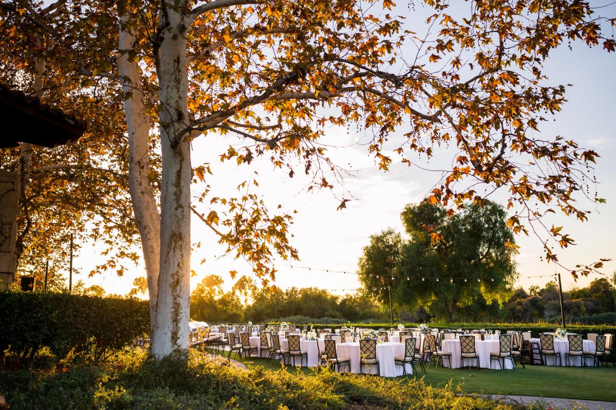 Sun setting over an outdoor wedding reception at Oak Creek Golf Club in Irvine, CA