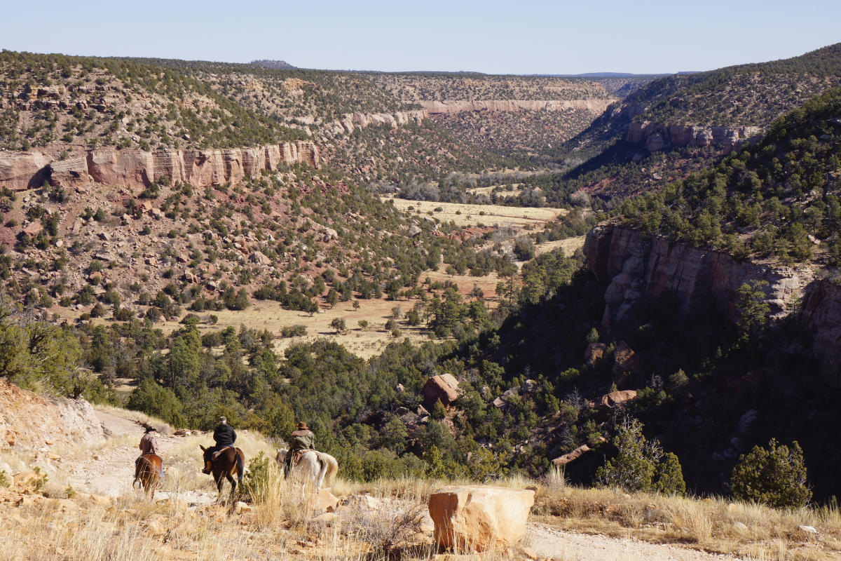 Riders descend into the newly accessible Cañon Largo