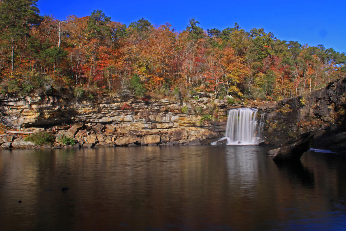 A waterfall framed by fall foliage at Little River Canyon National Preserve