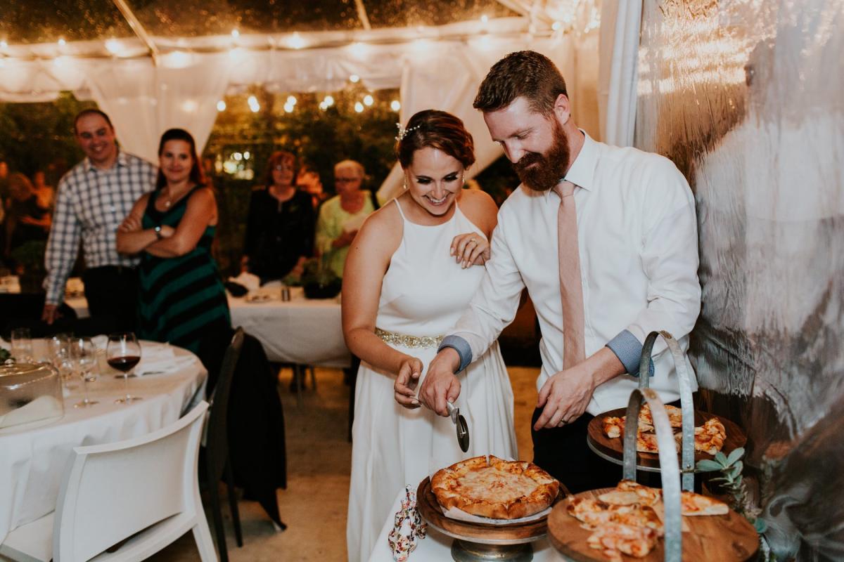 Bride and Groom cutting their "Pizza Cake"