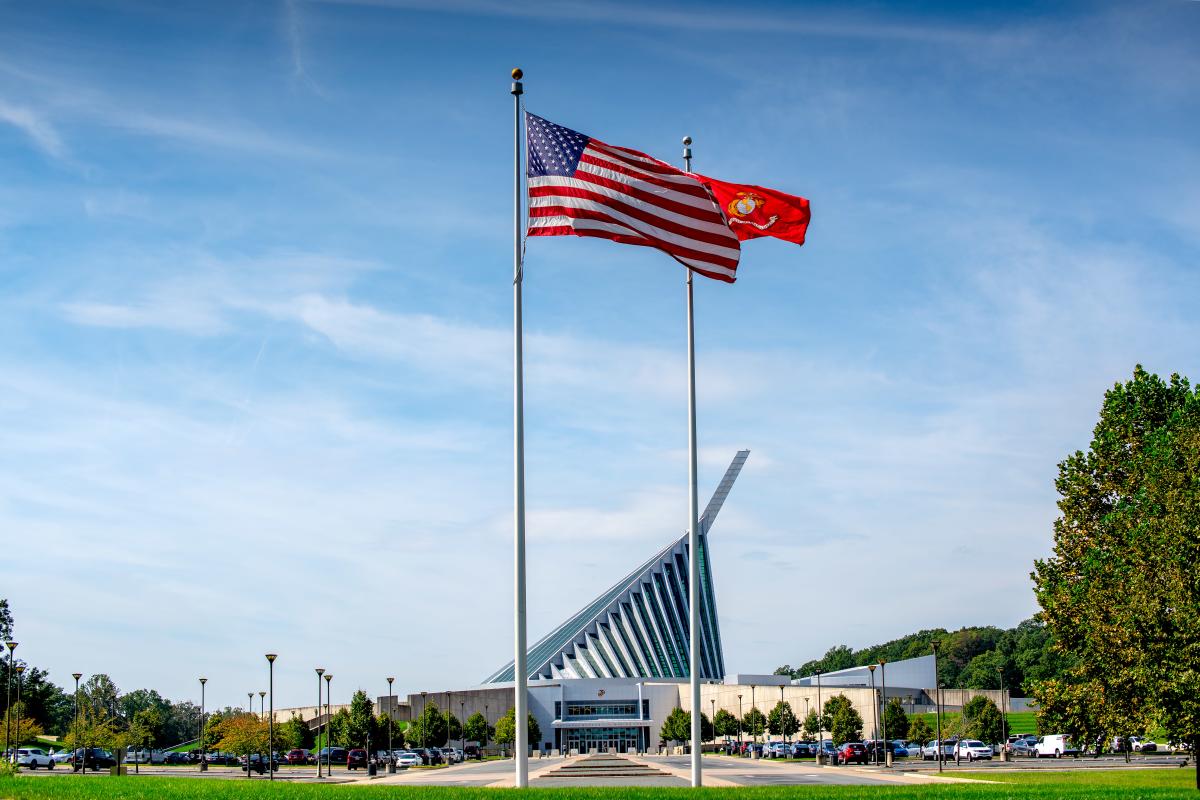 view of the outside of the national museum of the marine corps with flags in foreground