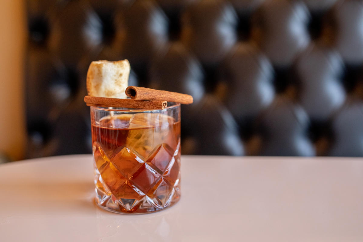 Old Fashion Drink With Cinnamon Sticks and Toasted Marshmallow