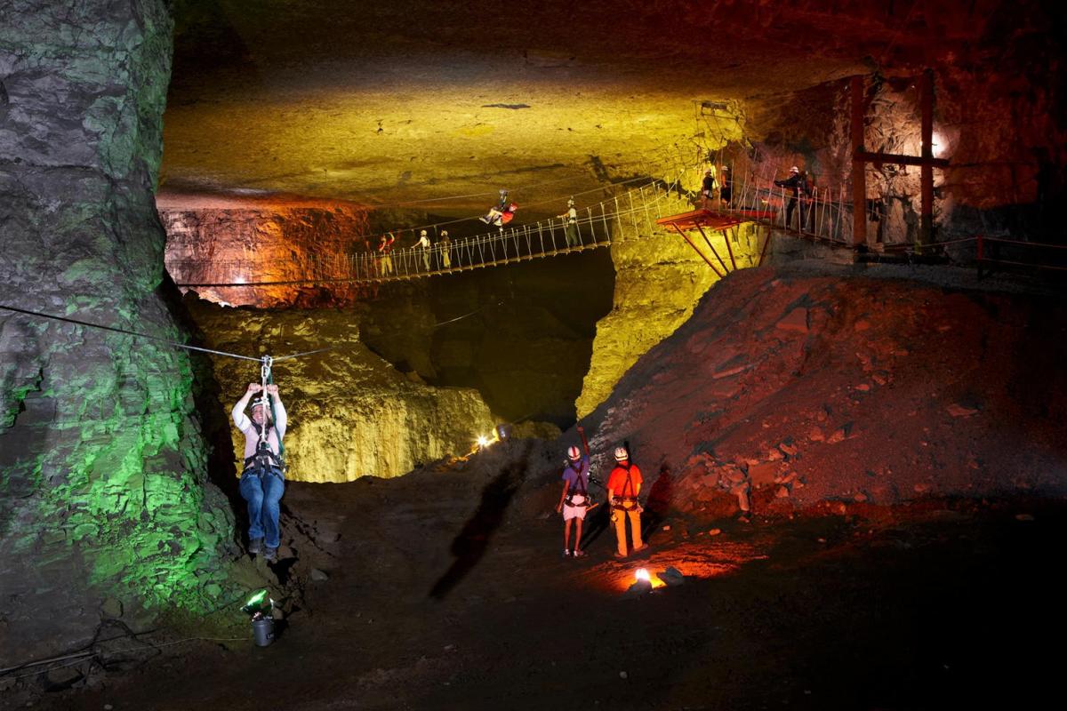 People in hard hats ziplining in Louisville Mega-Cavern