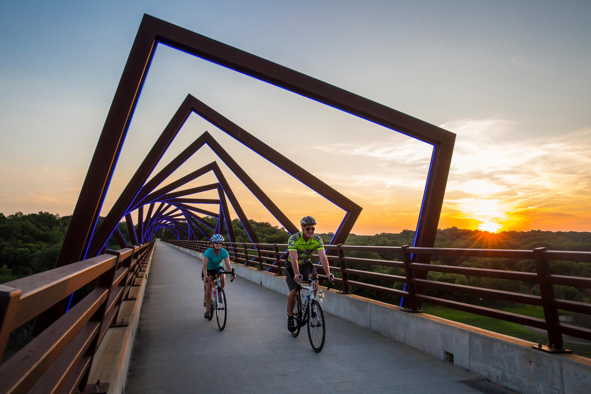 Two Cyclists Passing Over  High Trestle Trail Bridge In Greater Des Moines