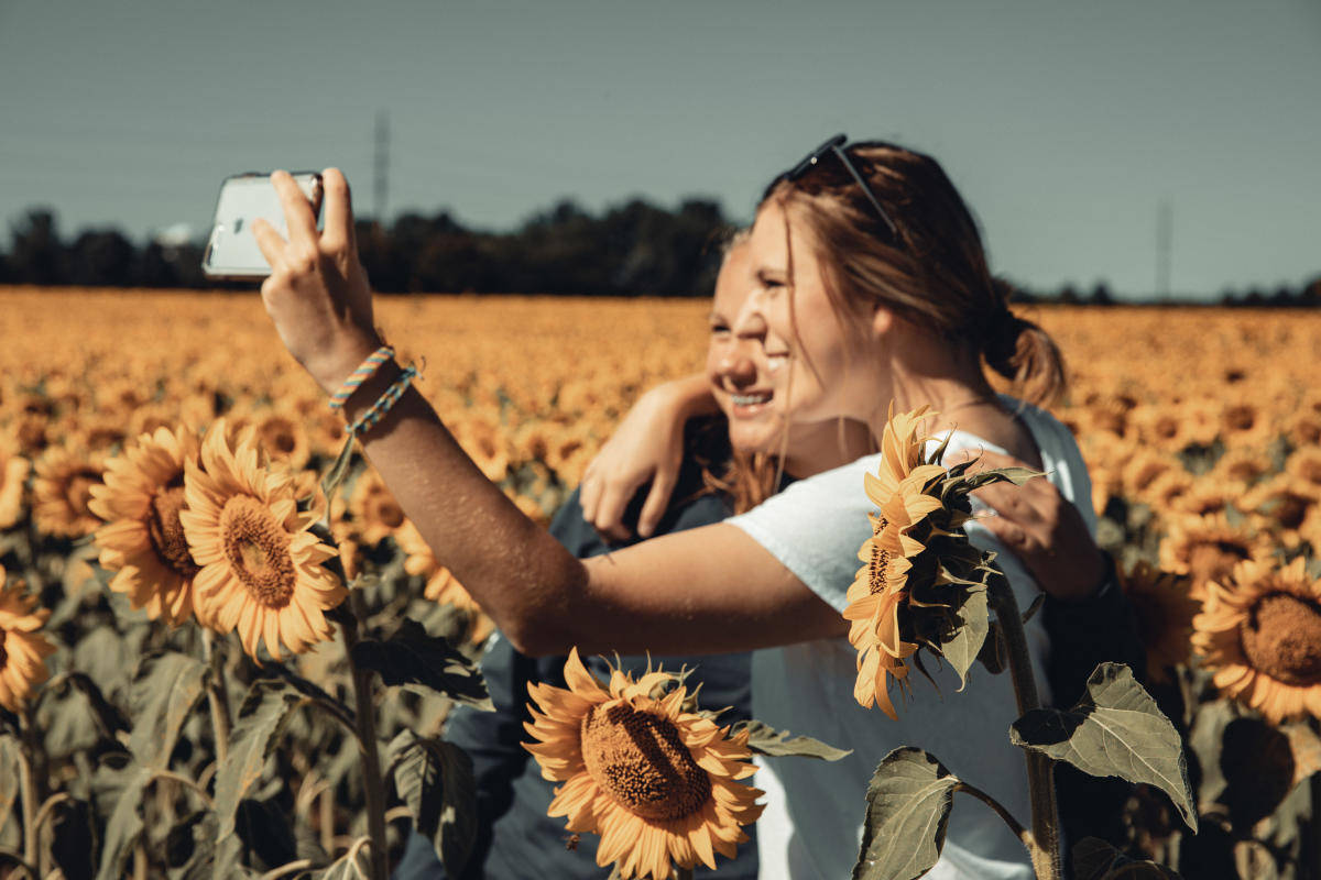 Taking selfies in a field of sunflowers at Babbette's Seeds of Hope