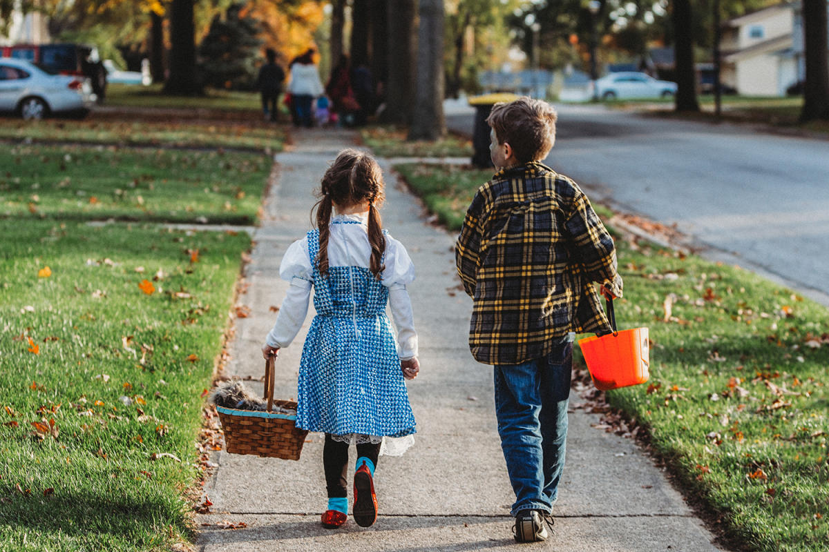 Boy and girl trick or treating on Halloween