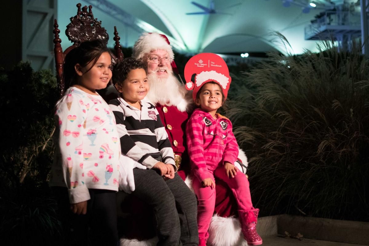 Children sit on Santa's lap at Holly Jolly Jingle in The Woodlands, TX