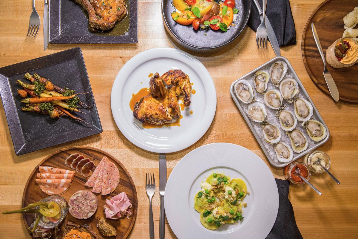 An array of platter with various food items on them from Under the Oak in Smithfield, NC