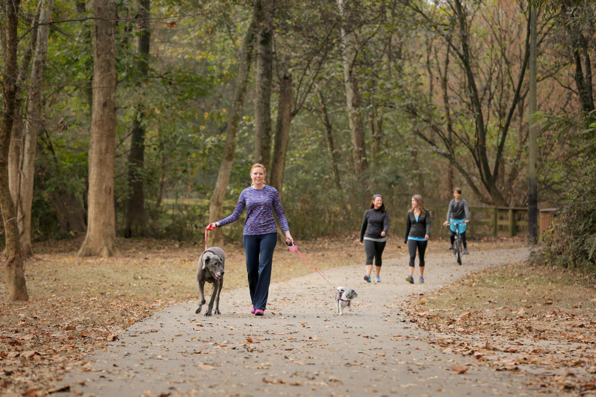 People Walking Dogs Along the Oconee River Greenway in Milledgeville, GA