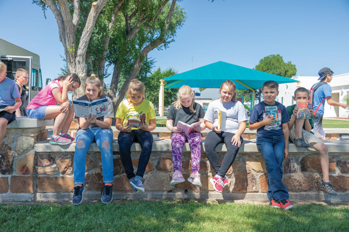 Elementary students showing off their bookmobile treasures.
