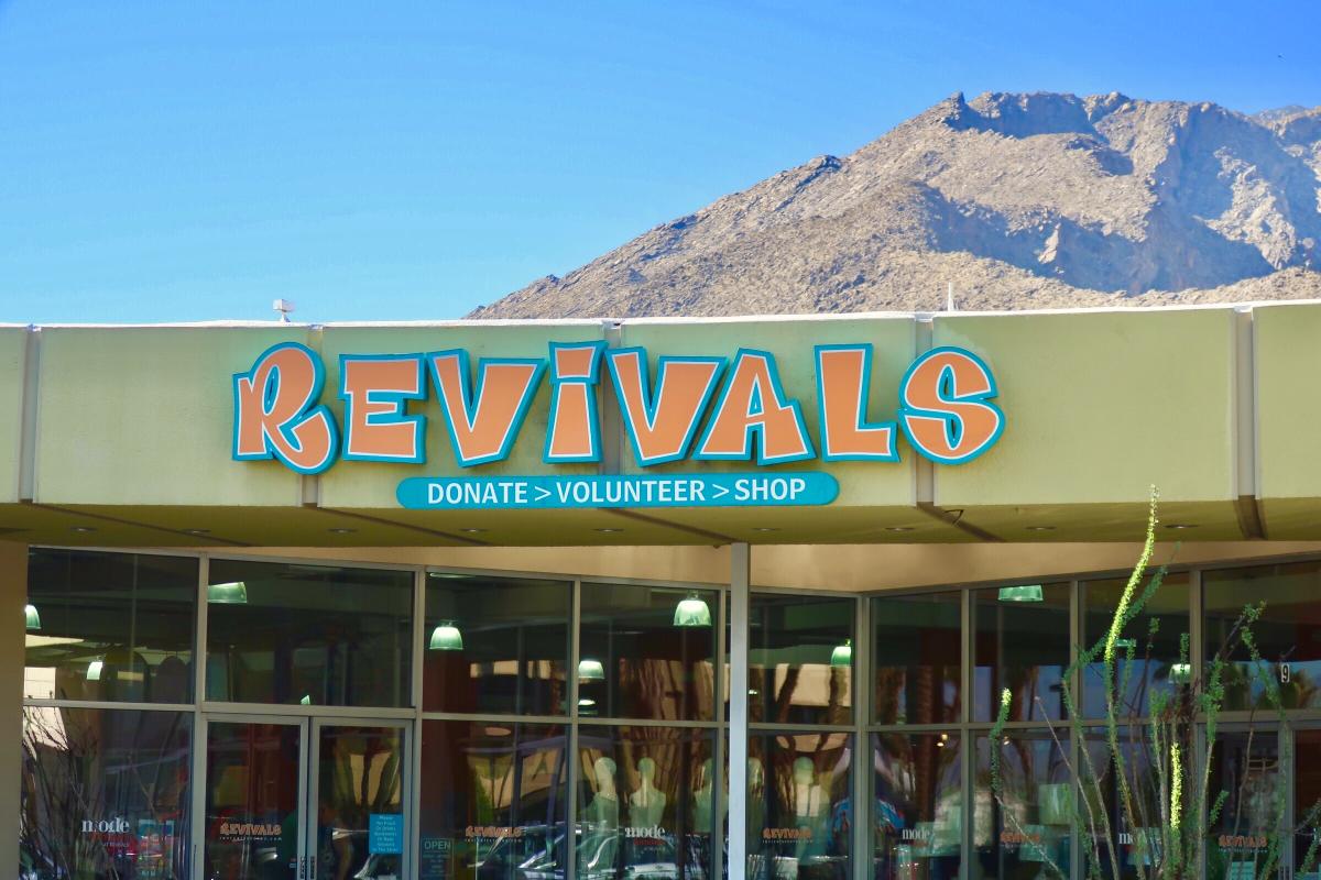 Store front Revivals with clear blue sky and rocky mountains behind the store.