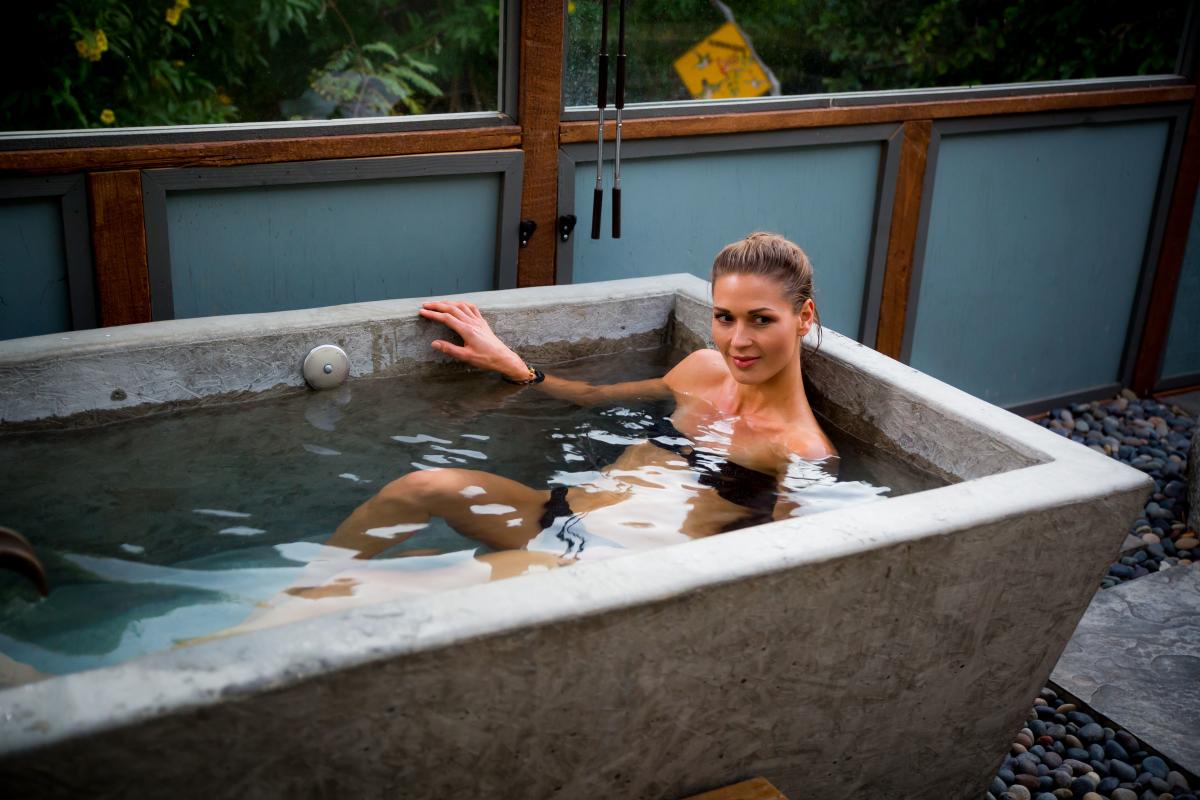 Woman relaxing in private mineral soaking tub at the Spring Resort and Spa in Desert Hot Springs, California