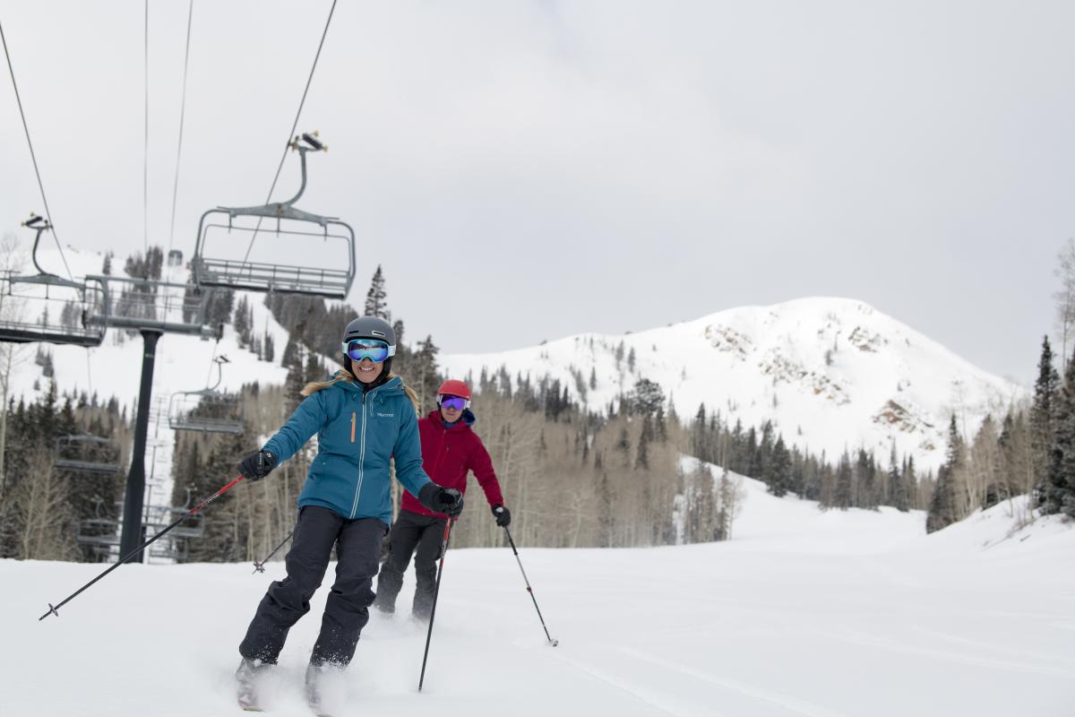 Couple Skiing Under Chairlift