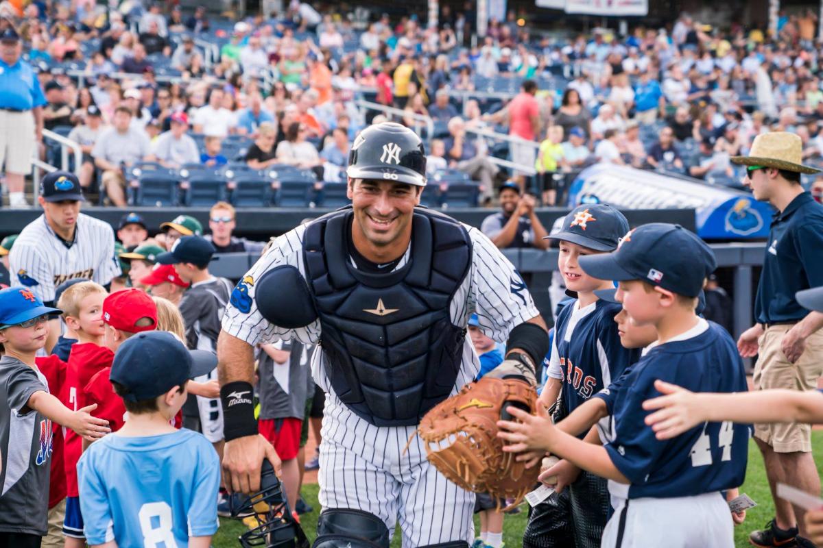 Trenton Thunder catcher giving kids high fives at opening night