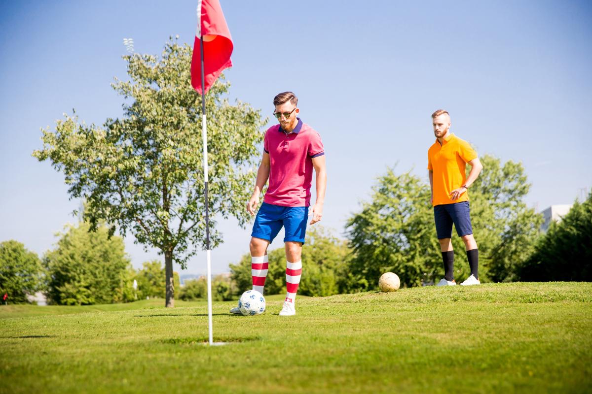 2 men playing footgolf