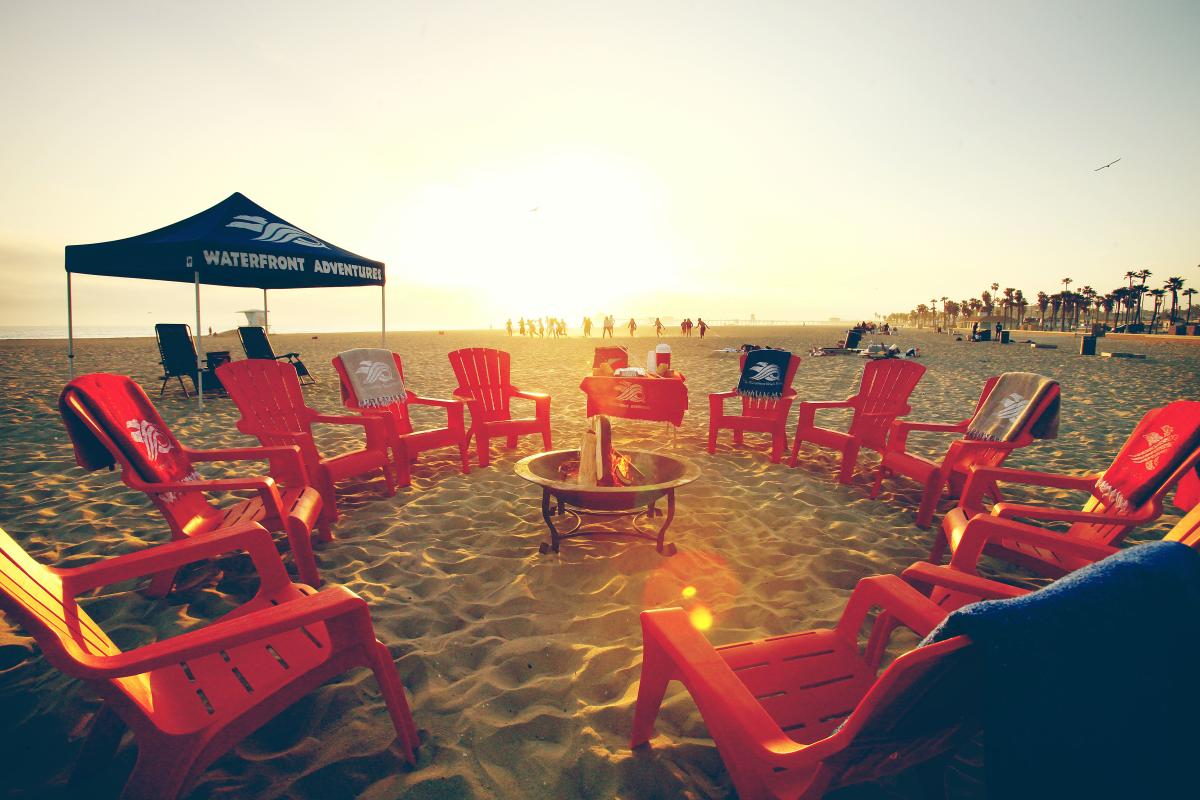 Chairs set in a circle around a bonfire in Huntington Beach
