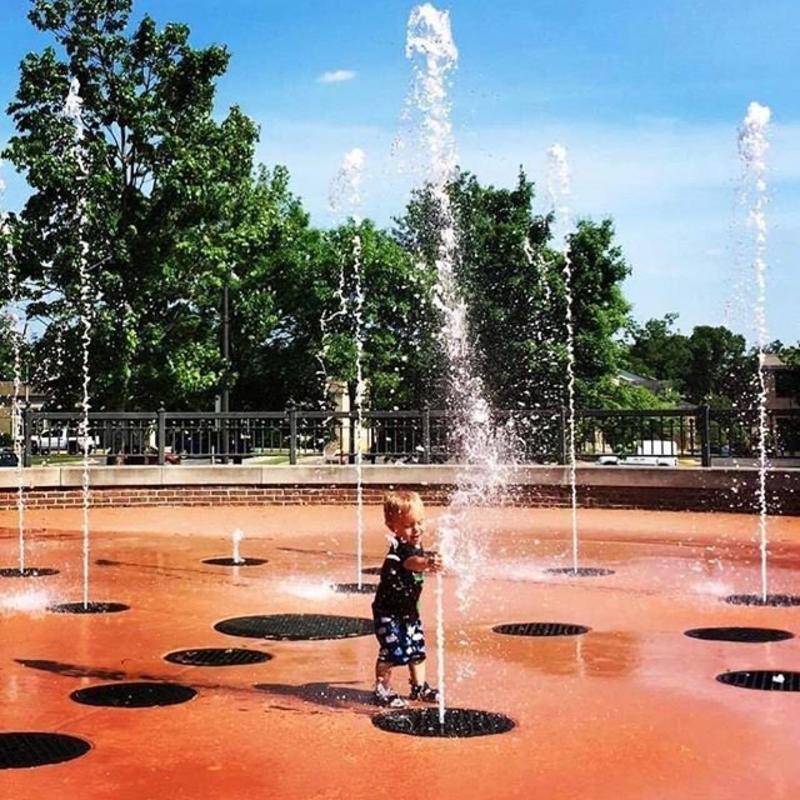 A boy playing in the water at Bicentennial Park Earlyworks Splashpad in Huntsville, AL