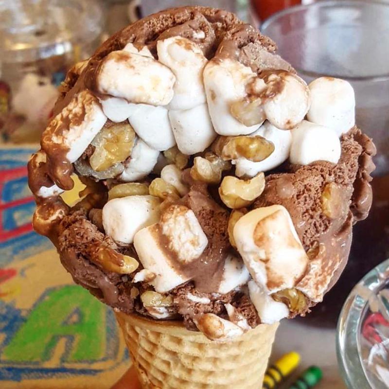 Rocky road ice cream cone with lots of marshmallows and nuts
