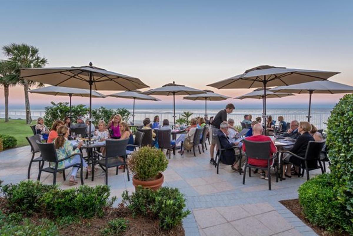 Patrons seated for oceanfront outdoor dining at ECHO restaurant on St. Simons Island, GA