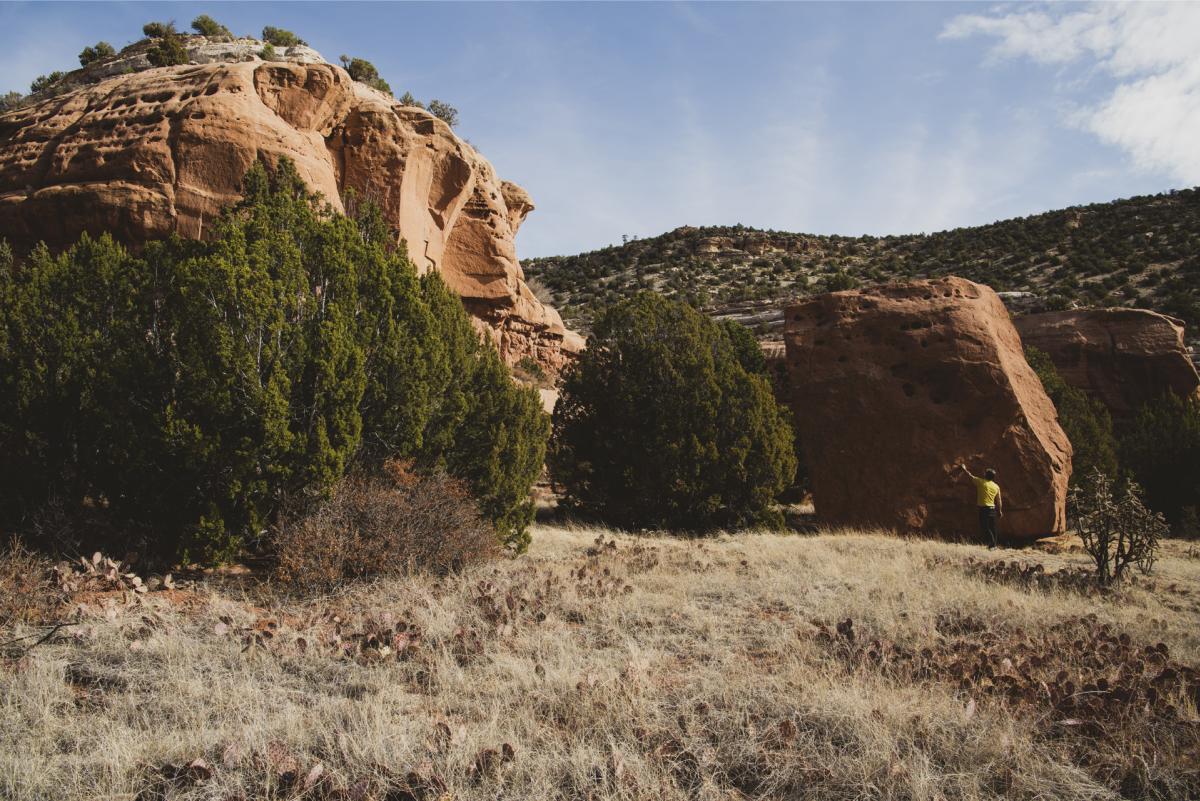 Hubert d’Autremont explores a boulder near the Mills Canyon Rim Campground, New Mexico Magazine