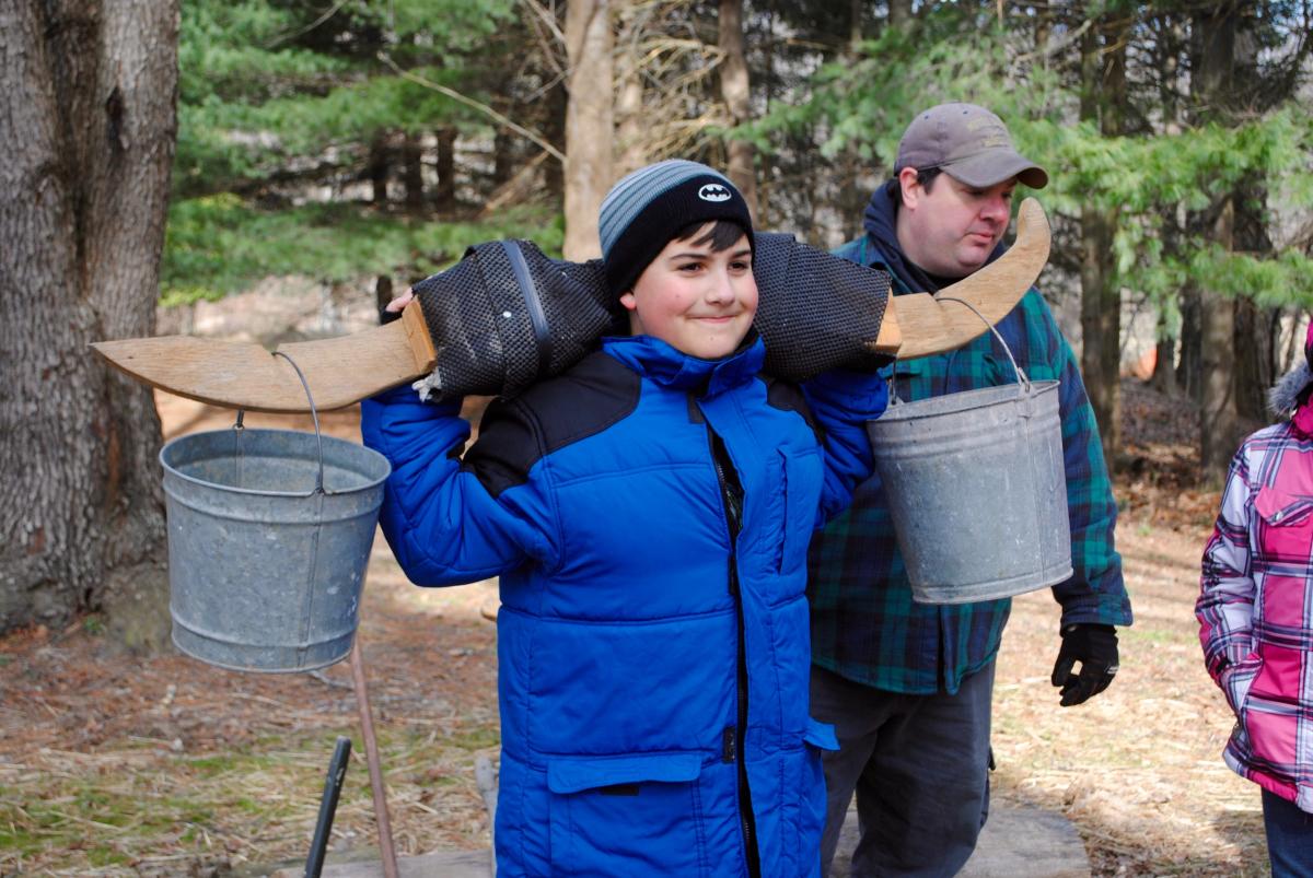 See what it's like to carry buckets of sap with a yoke during Maple Syrup Days at McCloud Nature Park. (Photo courtesy of Hendricks County Parks & Recreation)