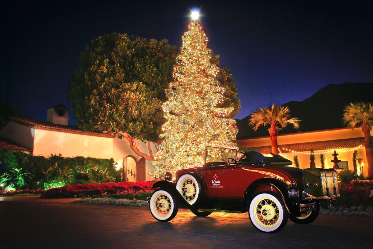 photo of a 1940s red car in front of a lit Christmas tree at The La Quinta Resort