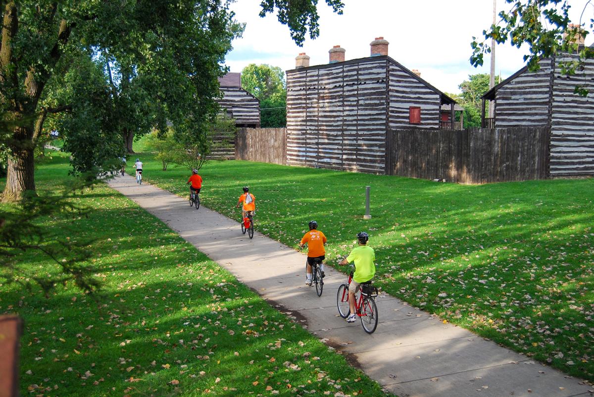 Family biking along Fort Wayne's downtown trails near the Old Fort