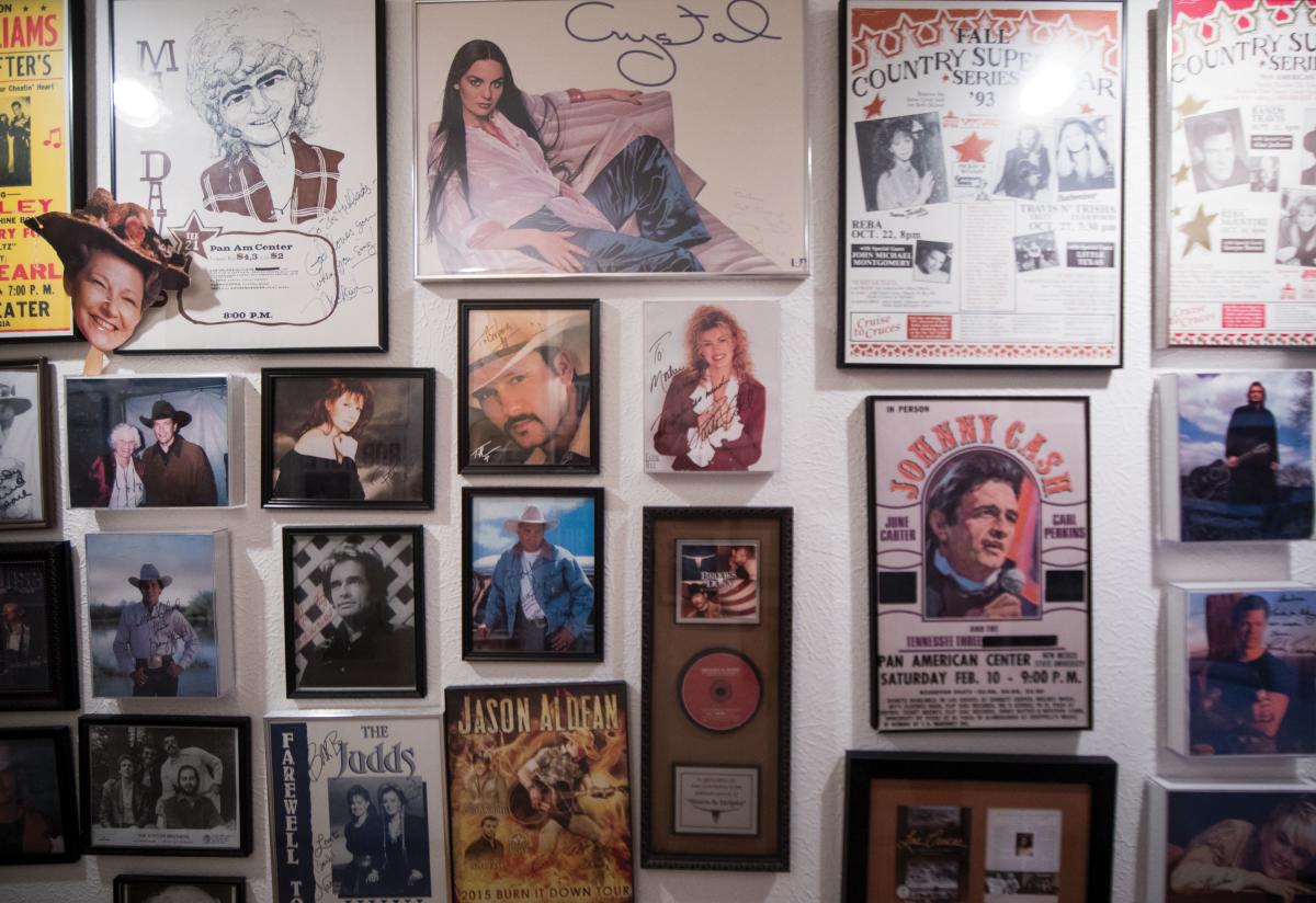 Upclose of Barbara Hubbard's hallway, and all of the gig posters of performers that she brought to New Mexico