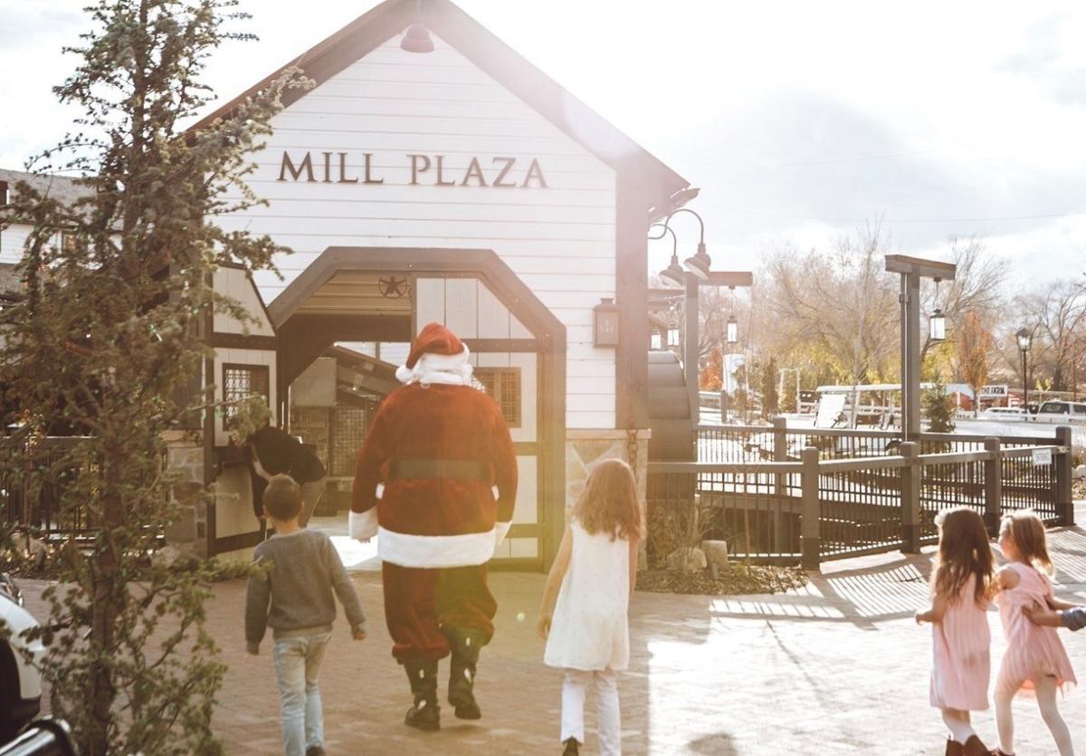 Kids walking with Santa to enjoy Breakfast with Santa at Gardner Village