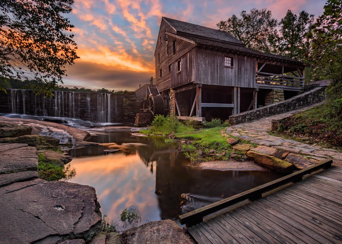 A colorful sunset highlights the historic beauty of the Yates Mill County Park and wildlife refuge center in North Carolina.