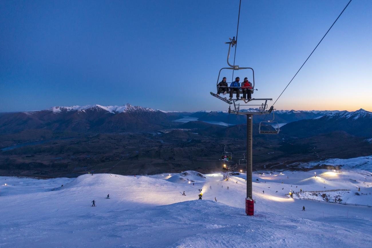 Friends on a chairlift at Coronet Peak Night Ski