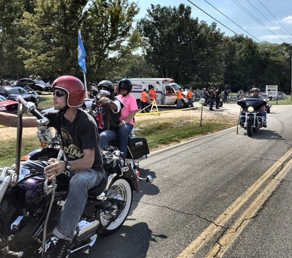 A line of bikes pulls out of a parking area and onto the street during the Trail of Tears Commemorative Motorcycle Ride
