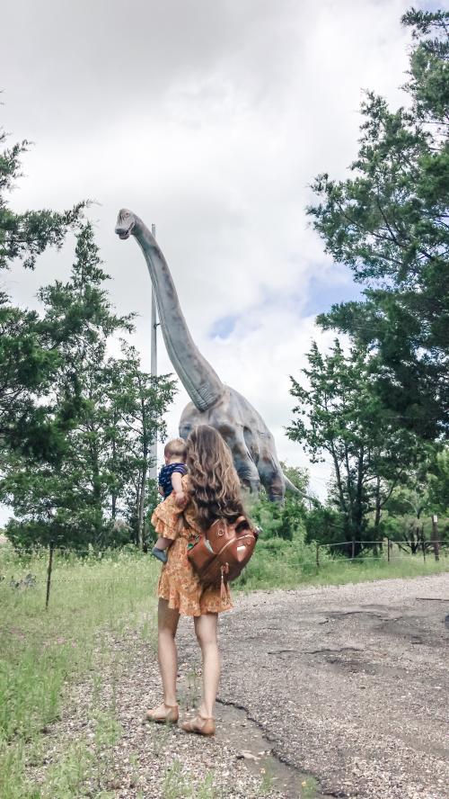 Dinosaur Park, woman and baby in front of dinosaur 