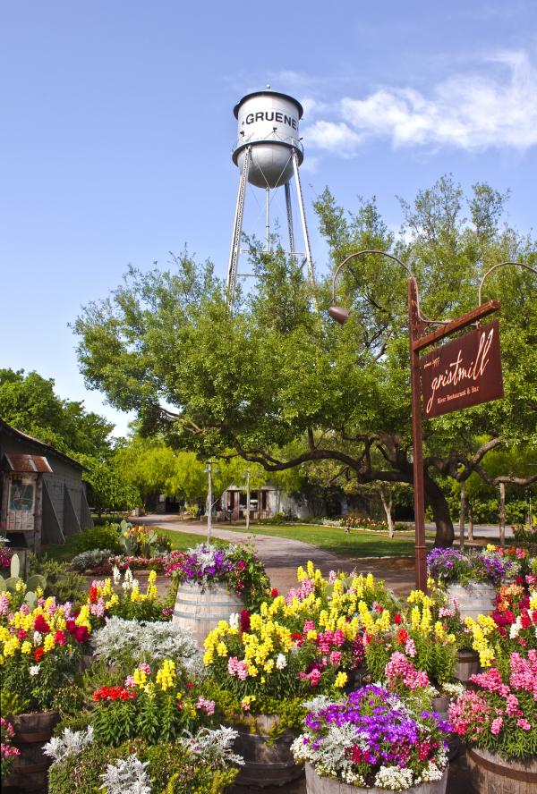 Gruene Tower and Gristmill restaurant sign with flowers