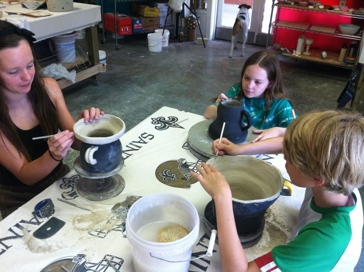 Artists decorate clay artwork at the Hand Star Clay Studio