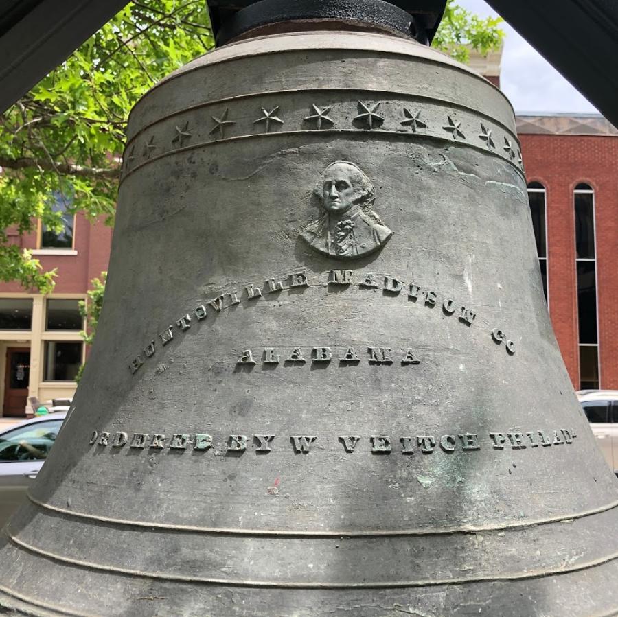 A close-up image of the Huntsville Madison County Courthouse Bell with legible text.