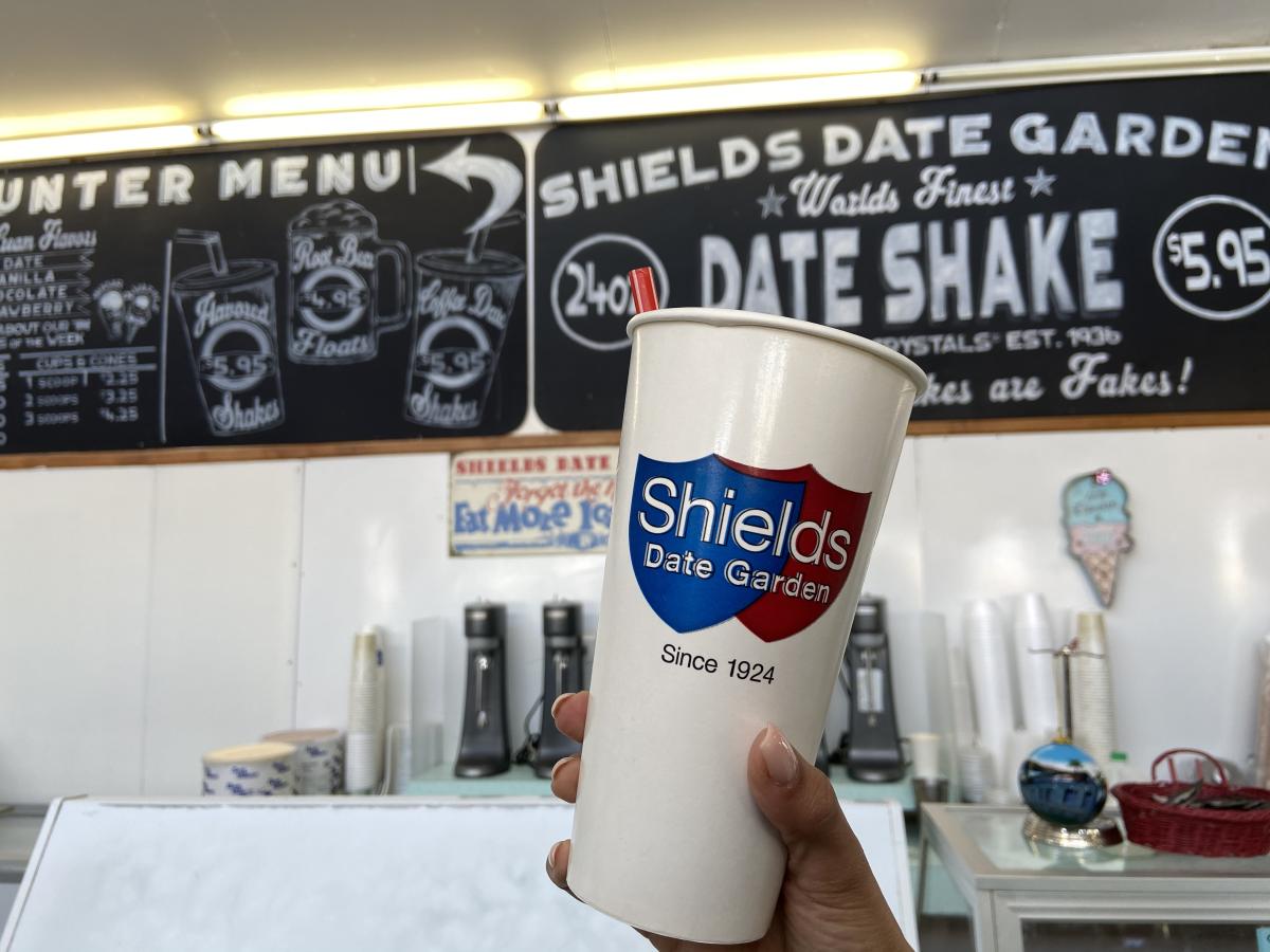 A date shake cup being help up