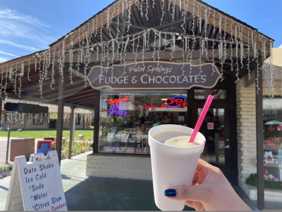 Date Shake being help up in front of shop