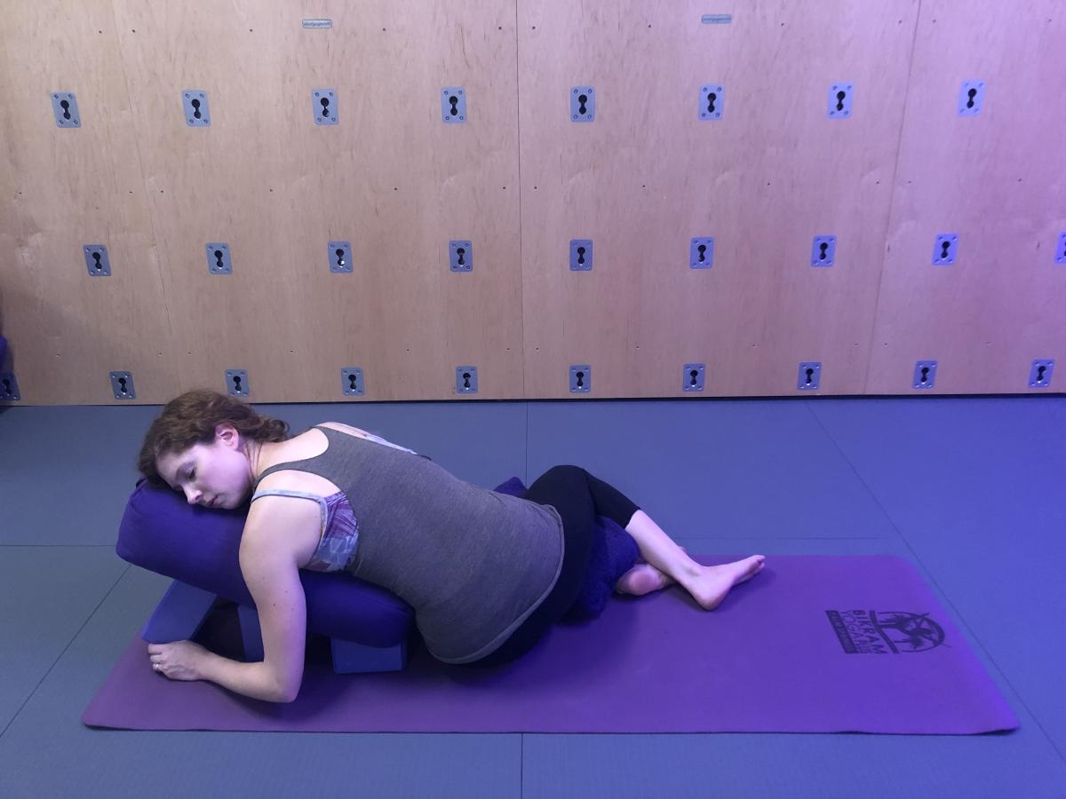 Instructor Caitlin Williams relaxes in a "Restorative Yin Yoga" pose at Bikran Yoga Plus in Palm Springs.