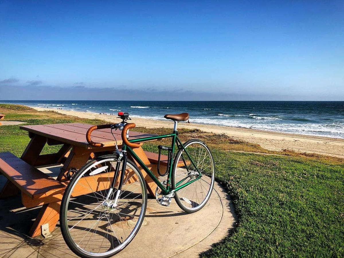 Bike leaning against a picnic table by the beach in Huntington Beach