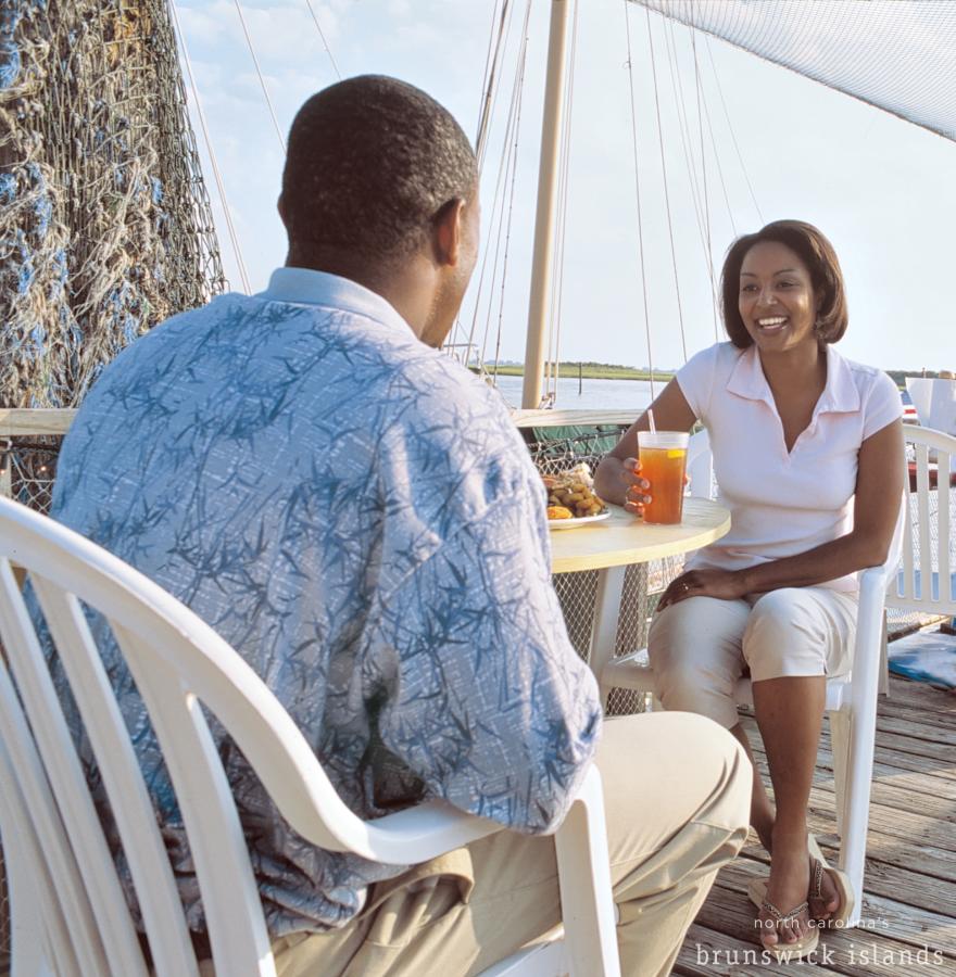 Couple Enjoying Outdoor Dining in North Carolina's Brunswick Islands