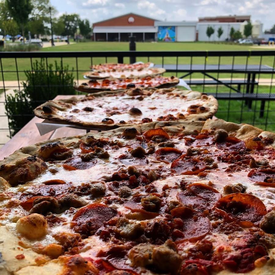 fresh-baked pizzas from Earth Stone Fire Pizza Campus 805 cool on a countertop.