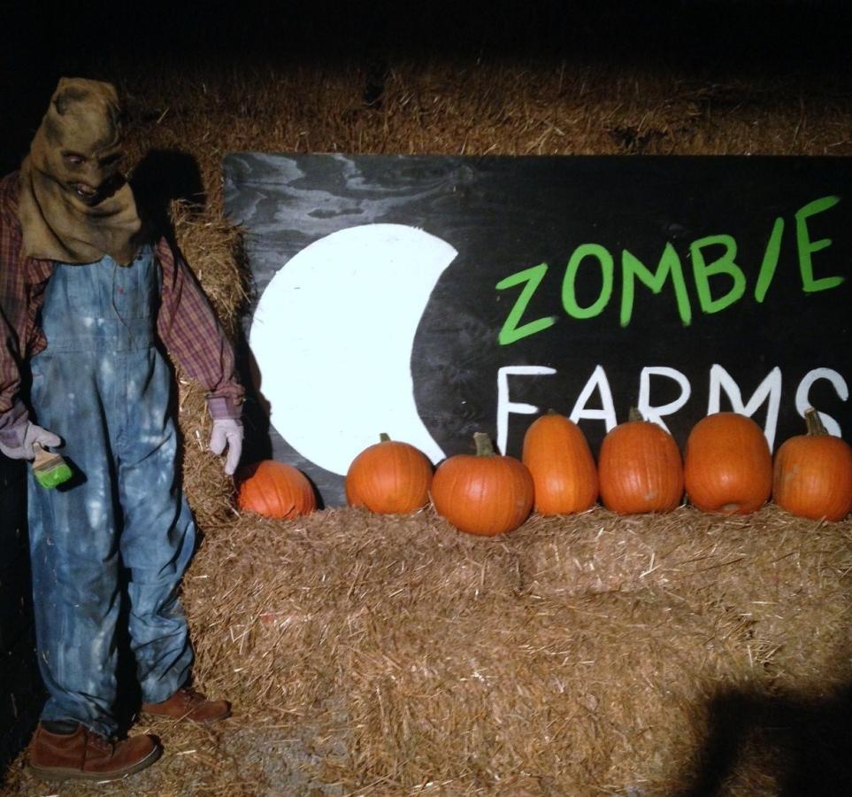 A scary costume, pumpkins and hay at Zombie Farms 