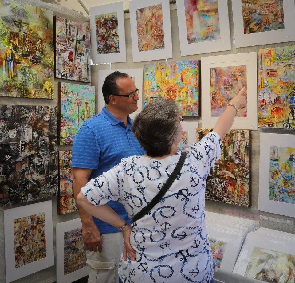Man and woman admiring art work on the wall at the Festival of the Arts