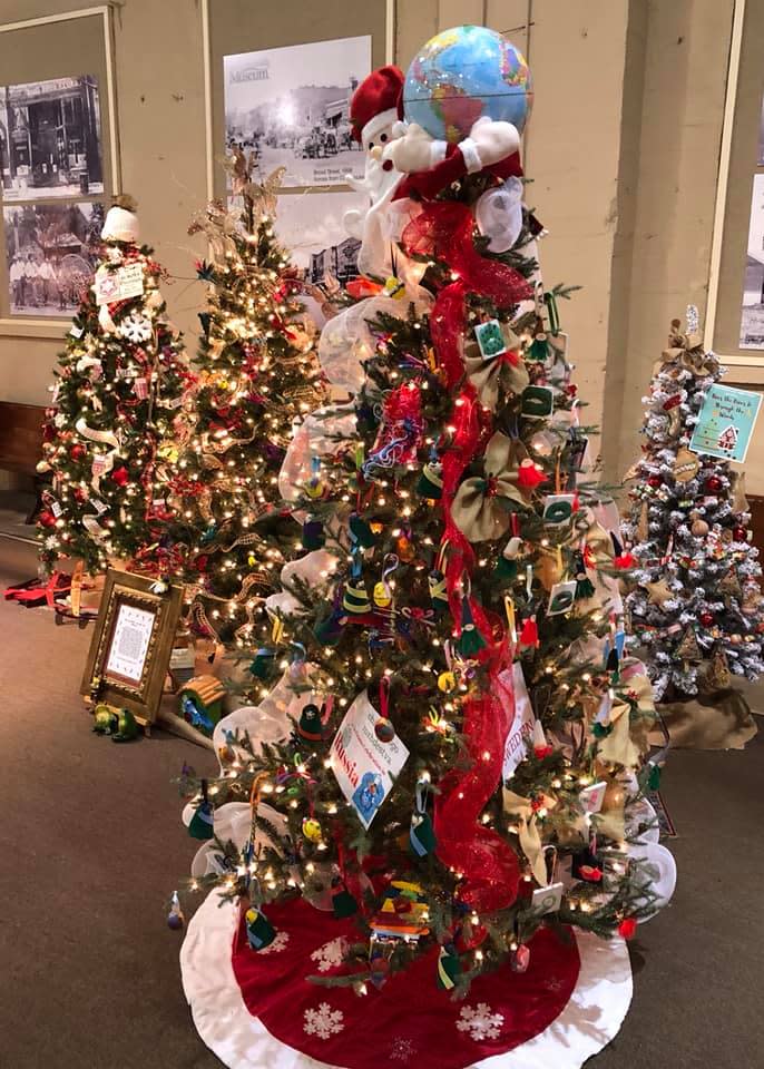 Four uniquely decorated Christmas trees in the lobby of the Guntersville Museum during the Festival of Trees