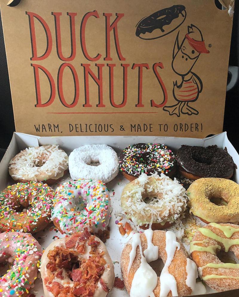 A cool dozen from Duck Donuts features favorite like bacon-topped maple cake donuts.