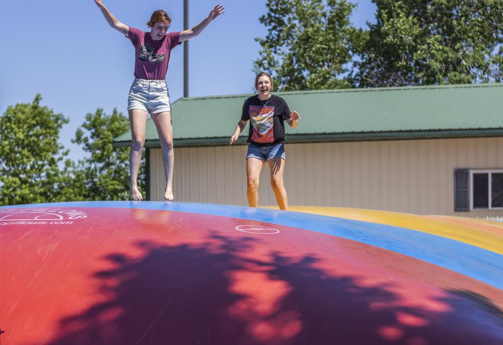 Two girls jumping on a jumping pad at Stoney Creek RV Resort in Osseo, WI