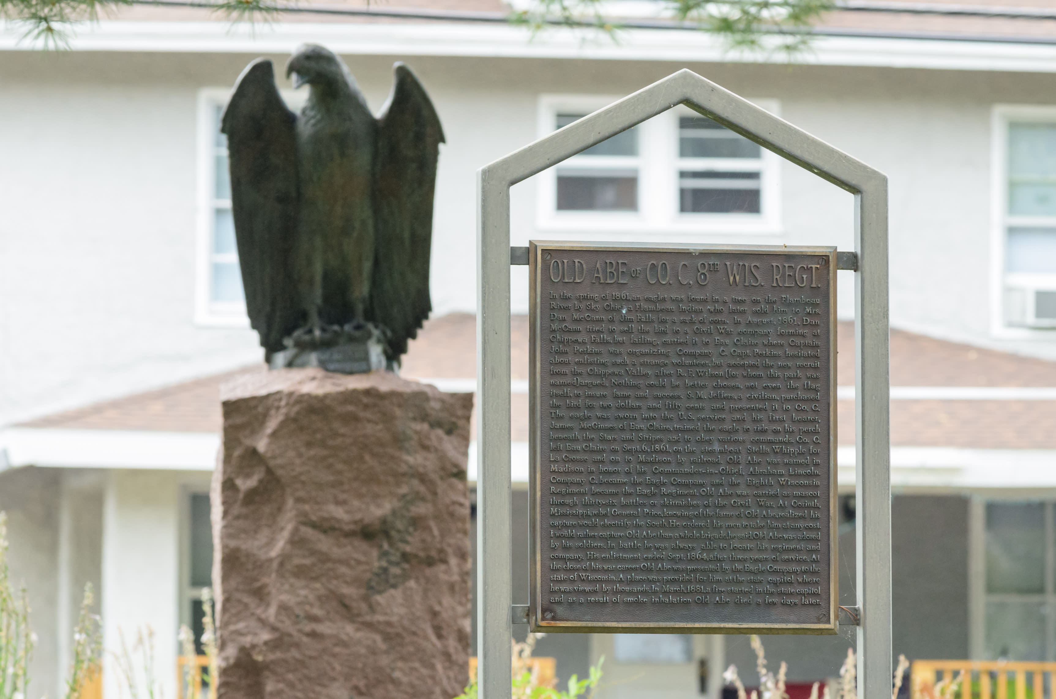 A statue of Old Abe and a historic marker about the eagle stand in downtown Eau Claire’s Wilson Park. Photo by Lee Butterworth/Volume One